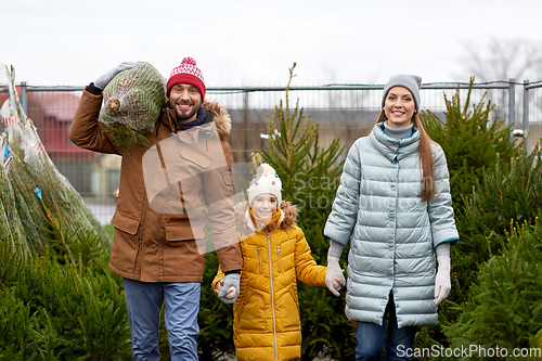 Image of happy family buying christmas tree at market