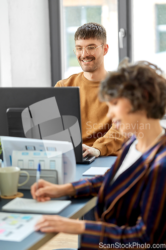 Image of male creative worker with laptop working at office