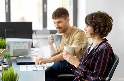 Image of team of startuppers drinking coffee at office