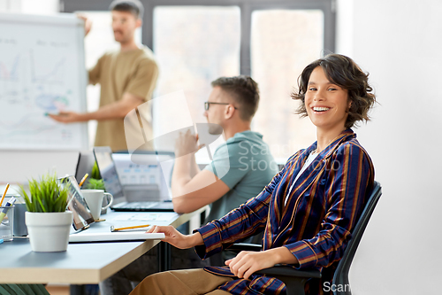 Image of smiling businesswoman at office conference