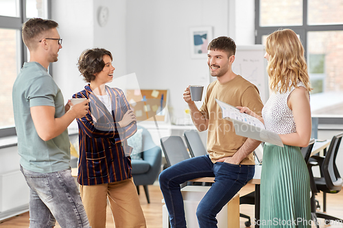 Image of team of startuppers drinking coffee at office