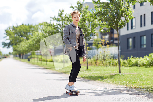 Image of teenage boy on skateboard on city street