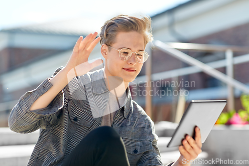 Image of teenage boy with tablet computer having video call