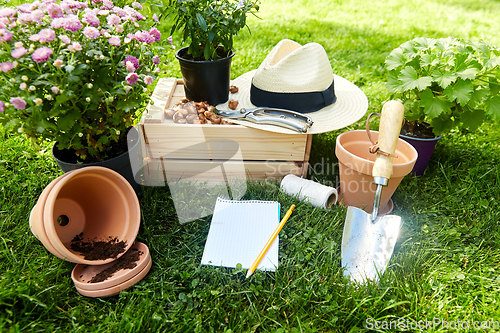 Image of garden tools, wooden box and flowers at summer