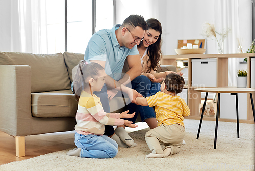 Image of portrait of happy family sitting on sofa at home