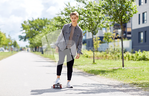 Image of teenage boy on skateboard on city street