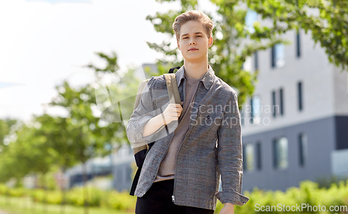 Image of teenage student boy with backpack in city