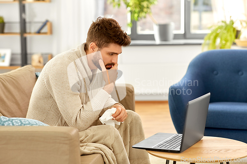 Image of sick man having video call on laptop at home