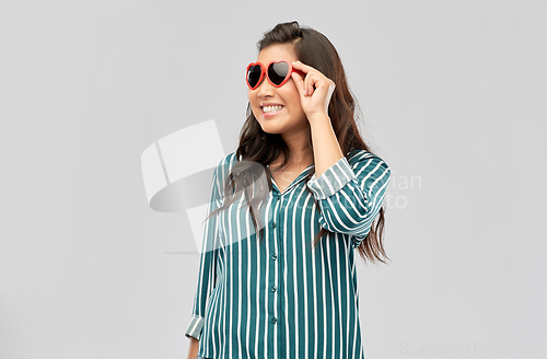 Image of happy asian woman with in heart shaped sunglasses