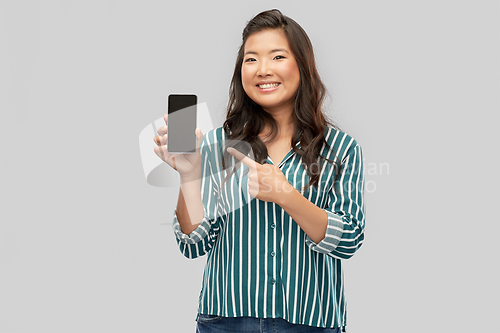 Image of happy asian woman over grey background