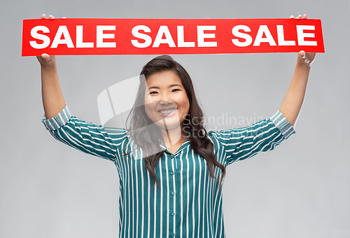 Image of happy smiling young asian woman with sale banner