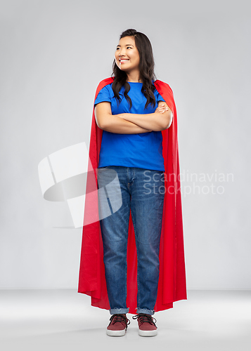 Image of happy asian woman in red superhero cape