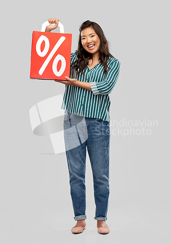 Image of asian woman with percentage sign on shopping bags