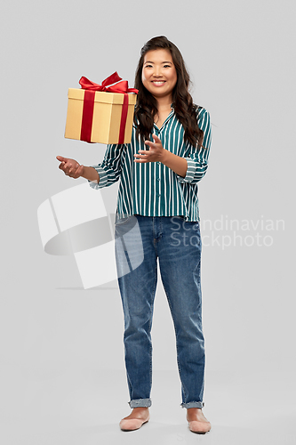 Image of happy asian woman with birthday present