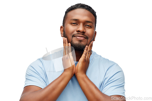 Image of happy african american man touching his beard