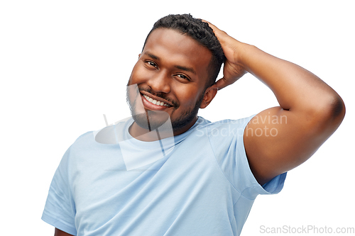 Image of happy african american man touching his hair