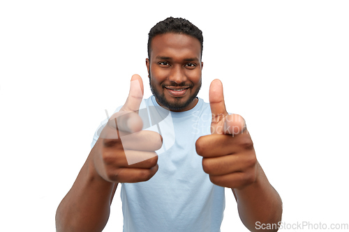 Image of smiling african american man pointing to camera