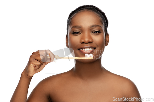 Image of african woman cleaning teeth with toothbrush