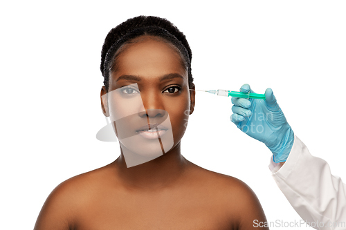 Image of african woman and hand in glove with syringe