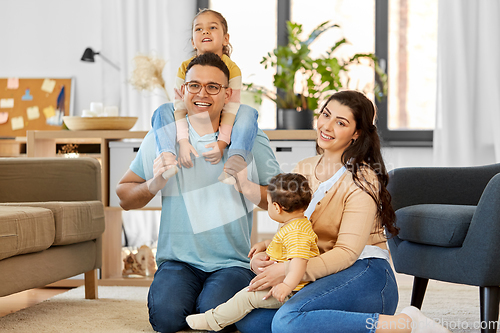 Image of portrait of happy family sitting on sofa at home