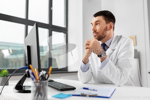 Image of male doctor with computer working at hospital