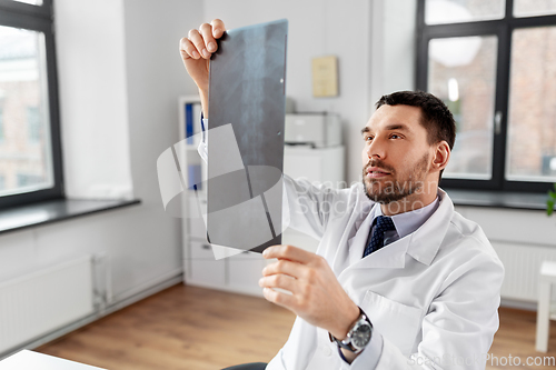 Image of male doctor with x-ray of spine at hospital