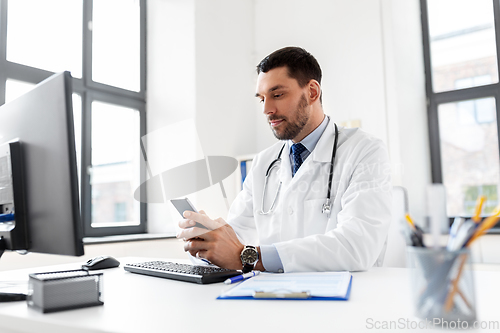 Image of male doctor with smartphone at hospital
