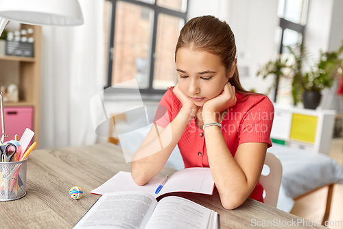 Image of student teenage girl reading book at home