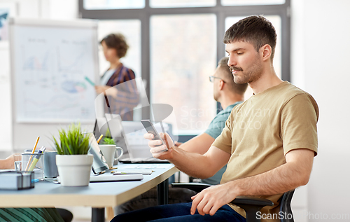 Image of man with smartphone at office conference