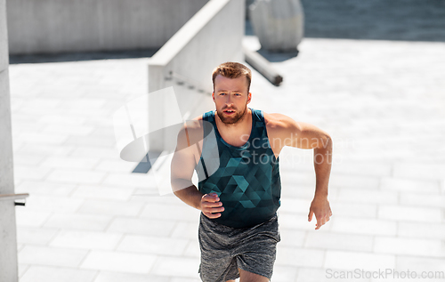 Image of young man running upstairs