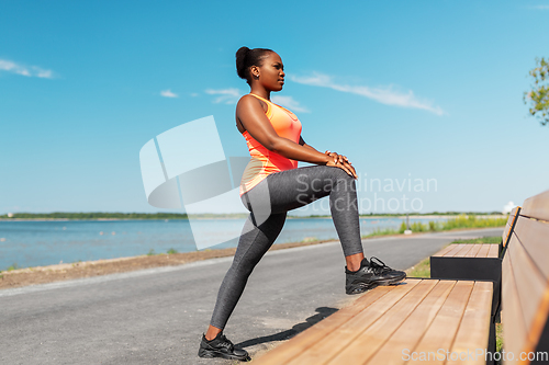 Image of african american woman doing sports at seaside