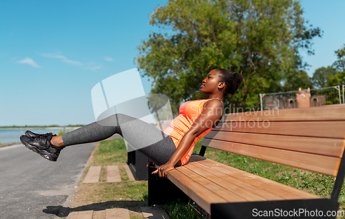 Image of african american woman doing sports at seaside