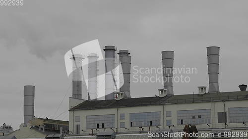 Image of Pipes with smoke in a factory building