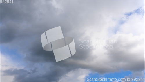 Image of Time lapse Fluffy clouds float across the blue sky.