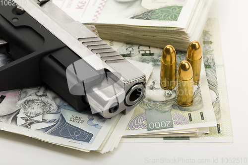 Image of gun and czech banknotes, crime concept