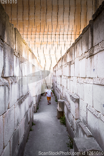 Image of Lonely young boy walking in a corridor