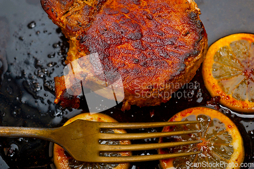Image of pork chop seared on iron skillet