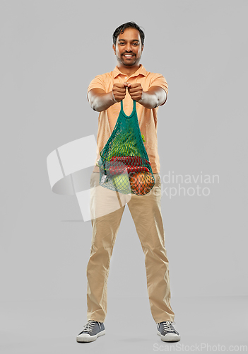 Image of happy indian man with food in reusable net tote