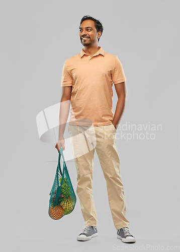 Image of happy indian man with food in reusable net tote