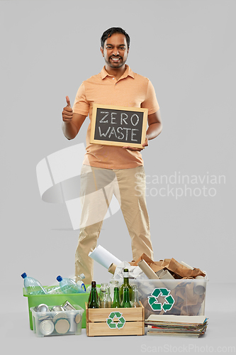Image of smiling man sorting paper, glass and plastic waste