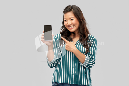 Image of happy asian woman over grey background