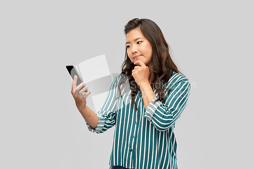 Image of asian woman using smartphone