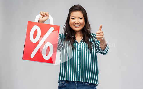 Image of asian woman with percentage sign on shopping bags