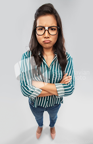 Image of displeased asian student woman in glasses