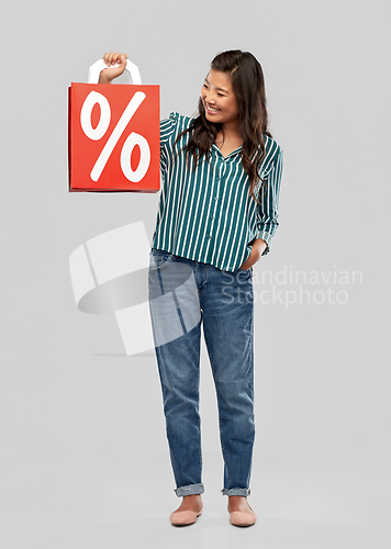 Image of asian woman with percentage sign on shopping bags