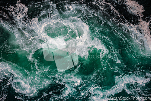 Image of Waves of water of the river and the sea meet each other during h