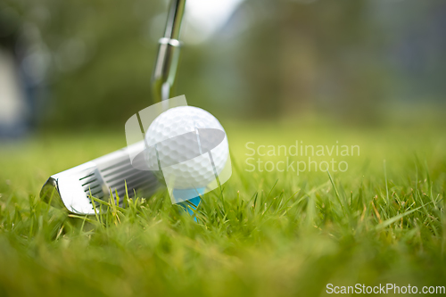 Image of Golf ball on tee in front of driver