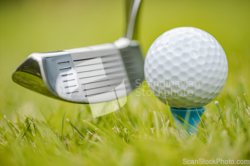 Image of Golf ball on tee in front of driver