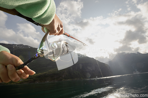 Image of Woman fishing on Fishing rod spinning in Norway.