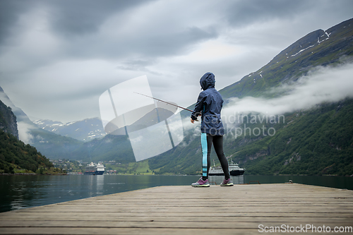 Image of Woman fishing on Fishing rod spinning in Norway.